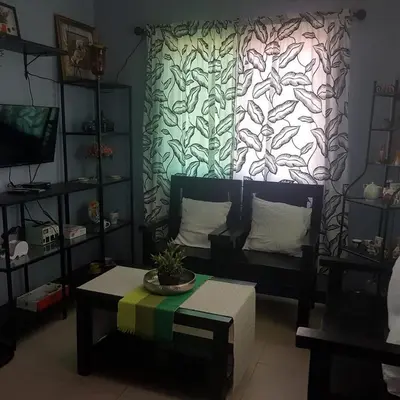 a living room with a couch and a coffee table at Fazing in Bacoor