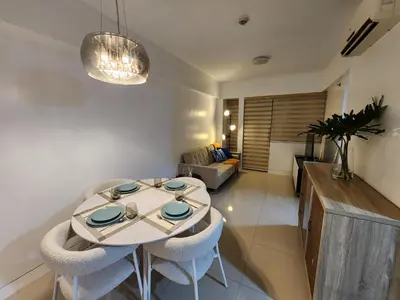 a living room with a table and a couch at 1BR Condo w Balcony near NAIA, Casino, Newport in Manila