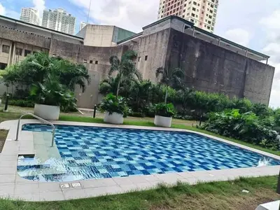 a large swimming pool in front of a building at RED RESIDENCES Makati in Manila