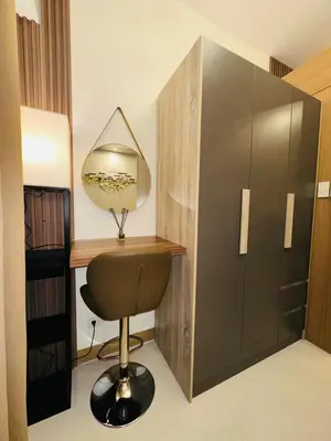 a room with a desk and a chair and a mirror at RED RESIDENCES Makati in Manila