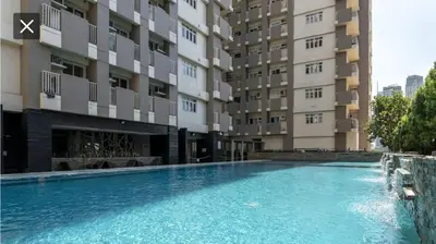 a swimming pool in front of a building at Laureano di trevi tower condominium Corporation in Manila