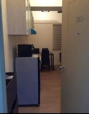 a room with a kitchen with a table and chairs at Laureano di trevi tower condominium Corporation in Manila