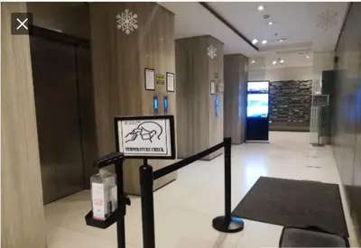 a lobby with a sign in the middle of a building at Laureano di trevi tower condominium Corporation in Manila