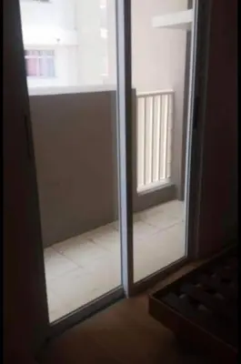 a glass door with a view of a room at Laureano di trevi tower condominium Corporation in Manila