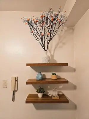 a shelf with a vase on a wall with flowers at Tokyo Oasis at Shore 1 Residences Tower A, Pasay, MOA in Manila