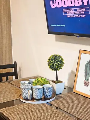 a table with four blue and white cups and a plant at Tokyo Oasis at Shore 1 Residences Tower A, Pasay, MOA in Manila