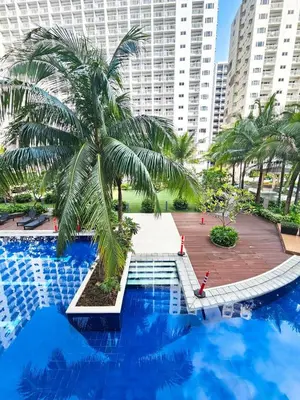 a palm tree sitting next to a swimming pool at Tokyo Oasis at Shore 1 Residences Tower A, Pasay, MOA in Manila