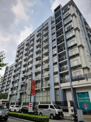 a large building with cars parked in front of it at One Palm Tree Villas in Manila