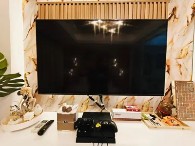 a flat screen tv sitting on top of a desk at Paris Hilton Beach resort in Manila