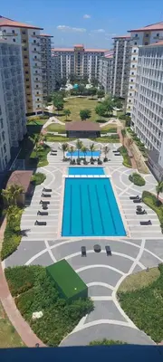 an aerial view of a resort with a swimming pool at Field Residences Condo Hotel Near Manila Airport in Manila