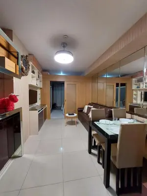 a kitchen and living room with a table and a couch at Executive Suite 519A at Shell Residence by GK Condotel in Manila