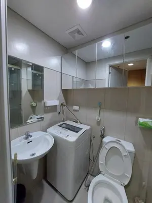 a bathroom with a white toilet and a sink at Executive Suite 519A at Shell Residence by GK Condotel in Manila