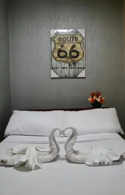a white bed with two pretzels on top of it at furutech hostel in Manila