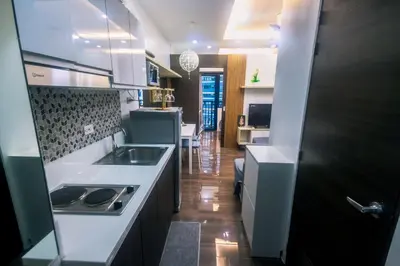 a kitchen with a sink and a stove at Cozy Crash Pad C Laughter Makati 2272 Swim Gym Park Internet 300 in Manila
