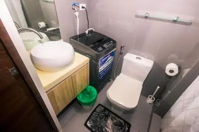 a small bathroom with a toilet and a sink at Cozy Crash Pad C Laughter Makati 2272 Swim Gym Park Internet 300 in Manila