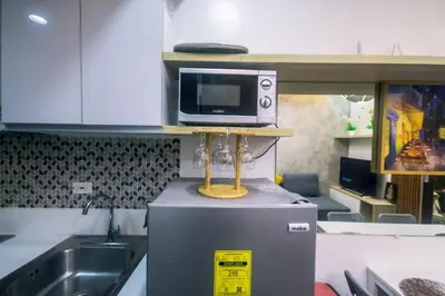 a microwave on top of a refrigerator in a kitchen at Cozy Crash Pad C Laughter Makati 2272 Swim Gym Park Internet 300 in Manila