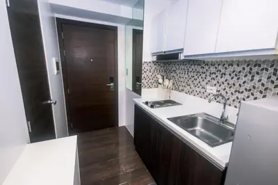 a kitchen with a sink and a counter top at Cozy Crash Pad C Laughter Makati 2272 Swim Gym Park Internet 300 in Manila