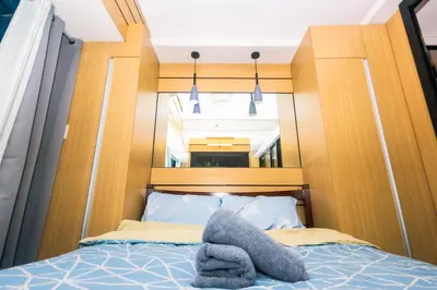 a bed with a stuffed animal on top of it at Hidden Gem Coolest Crash spot Makati Swim Gym Park 2320 in Manila
