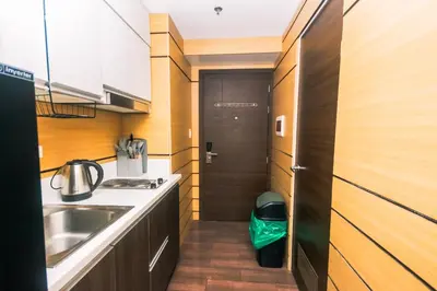 a small kitchen with a sink and a door at Hidden Gem Coolest Crash spot Makati Swim Gym Park 2320 in Manila
