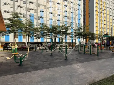 a park with swings and trees in front of a building at Cozy CondoVibe 2 BR Staycation near SM East Ortigas with Netflix! in Manila