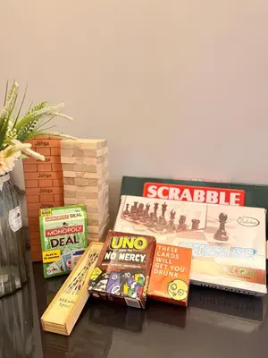 a pile of books sitting on top of a table at Cozy CondoVibe 2 BR Staycation near SM East Ortigas with Netflix! in Manila