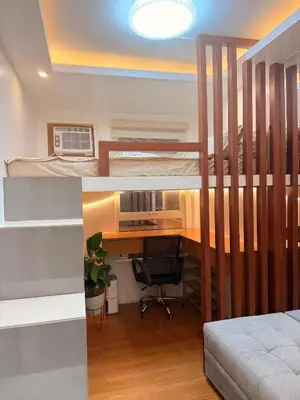 a bedroom with a bunk bed and a desk at Cozy CondoVibe 2 BR Staycation near SM East Ortigas with Netflix! in Manila