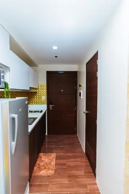a kitchen with white cabinets and a door to a kitchen at Secret Makati Love Haven Swim Gym Park Laugh 300MB in Manila