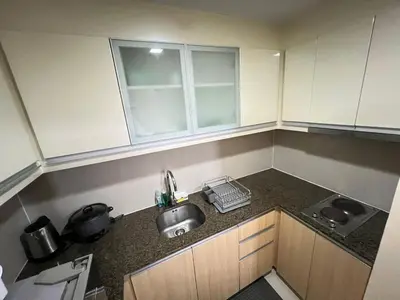 a small kitchen with a sink and a counter top at 101 Newport in Manila
