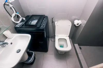 a bathroom with a white toilet and a sink at Royal Polo club Air condo Makati Swim Gym Park 300 mbps in Manila