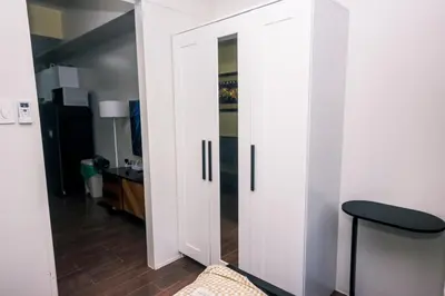 a room with white cabinets and a black stool at Royal Polo club Air condo Makati Swim Gym Park 300 mbps in Manila