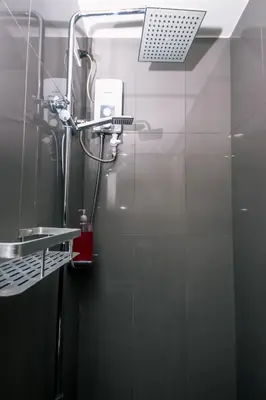a shower in a bathroom with a glass door at Royal Polo club Air condo Makati Swim Gym Park 300 mbps in Manila