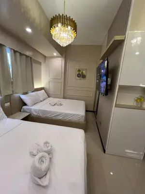 a hotel room with two beds and a tv at Radiance Manila Bay in Manila