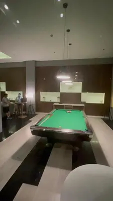 a pool table in a room with people sitting at Radiance Manila Bay in Manila