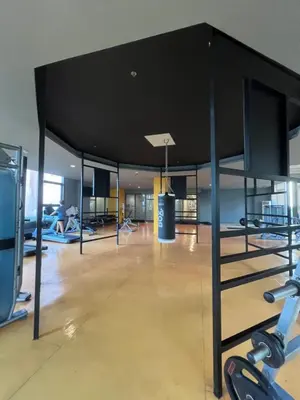 a gym with exercise equipment and a basketball hoop at Radiance Manila Bay in Manila