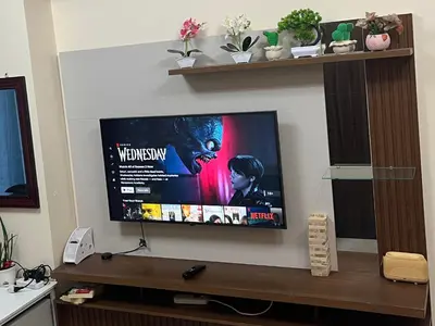 a flat screen tv hanging on a wall at BayFront 1BR Condo in Pasay with FREE Wi-Fi, Netflix, Pool Access & Gym, Near NAIA Airport, MOA, OKADA, CCP & PICC in Manila