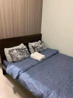 a bed with blue sheets and pillows on it at VSV Luxury Family Suite staycation Moa shore2 tower2 unit1122 in Manila