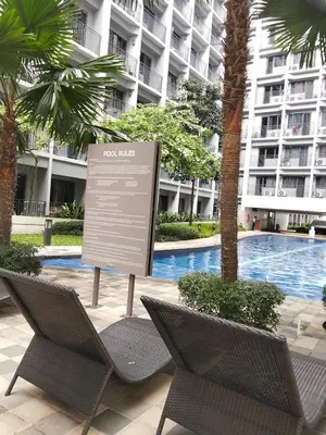 two chairs and a sign in front of a building at VSV Luxury Family Suite staycation Moa shore2 tower2 unit1122 in Manila