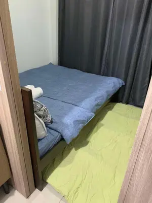a small bed in a room with a curtain at VSV Luxury Family Suite staycation Moa shore2 tower2 unit1122 in Manila
