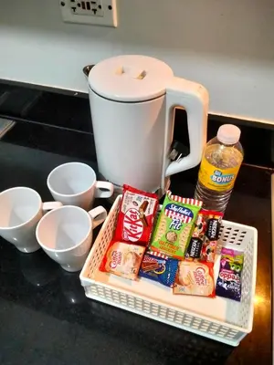 a basket of snacks and a coffee maker on a counter at VSV Luxury Family Suite staycation Moa shore2 tower2 unit 1122 in Manila