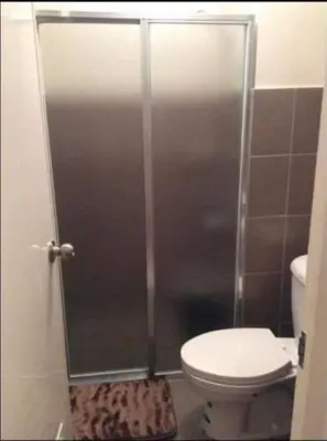 a shower stall in a bathroom with a toilet at Laureano di trevi tower 2 Condominium Corporation in Manila