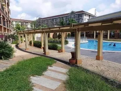 a pavilion with a swimming pool in a building at Cozy 1 Bedroom Unit Arezzo Place Pasig in Pasig
