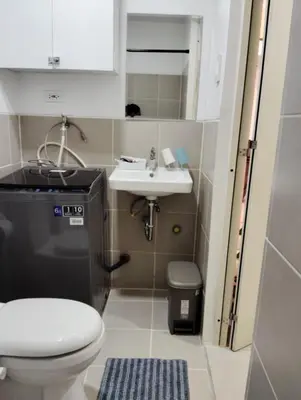 a small bathroom with a toilet and a sink at Condo sa south residences tower 3 in Manila