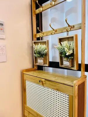 a mirror with two plants on top of a dresser at CityZen Suite in Trece Martires