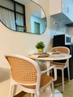 a table with chairs and a mirror on the wall at CityZen Suite in Trece Martires