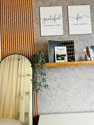 a shelf with cards and plants on a wall at CityZen Suite in Trece Martires