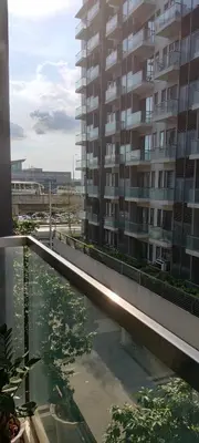 a large apartment building with a reflecting pool in front of a building at Room Near Naia Terminal 3 and New World Resort in Manila