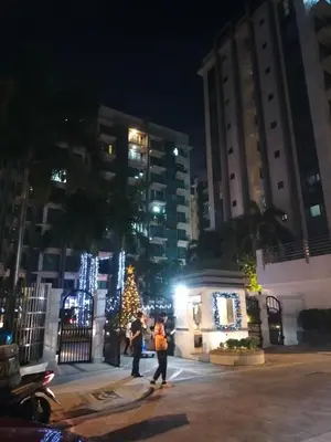 a group of people walking in front of a christmas tree at Room Near Naia Terminal 3 and New World Resort in Manila