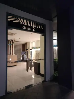 a glass door to a building with a sign that reads cluster at Room Near Naia Terminal 3 and New World Resort in Manila