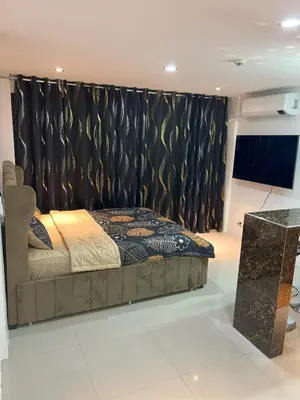 a bedroom with a bed and a black curtain at La Nikolina, Cozy Studio near MOA, CCP & Star City, Pasay in Manila