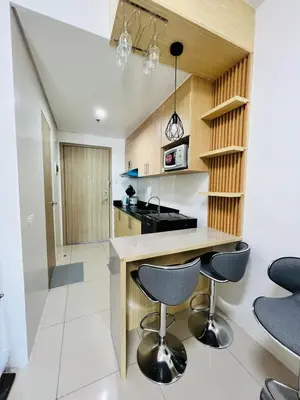 a kitchen with a counter and two stools at D Crib at Breeze Residences Pasay City Philippines in Manila